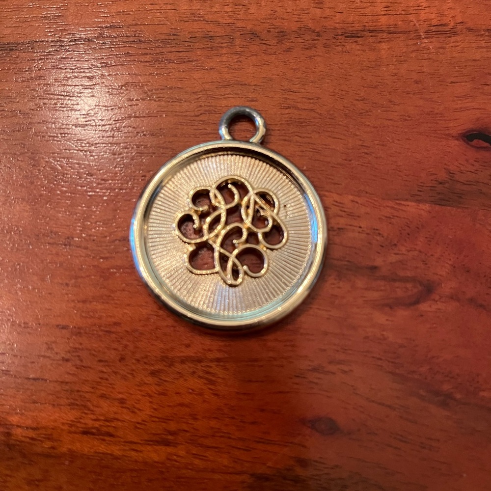 Gold-Tone Circular Pendant with Intricate Design